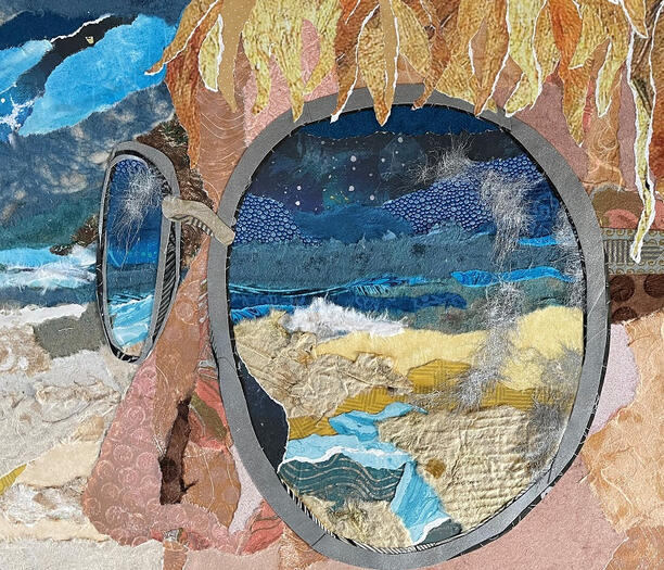 Paper collage "painting" of beach reflected in person's sunglasses.